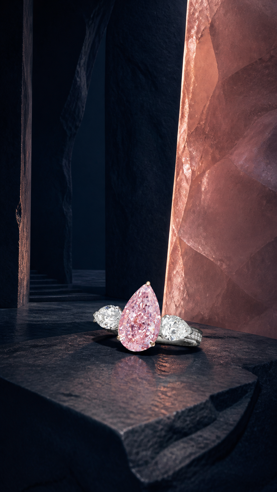 Pear shape pink diamond ring in a dark stone gallery